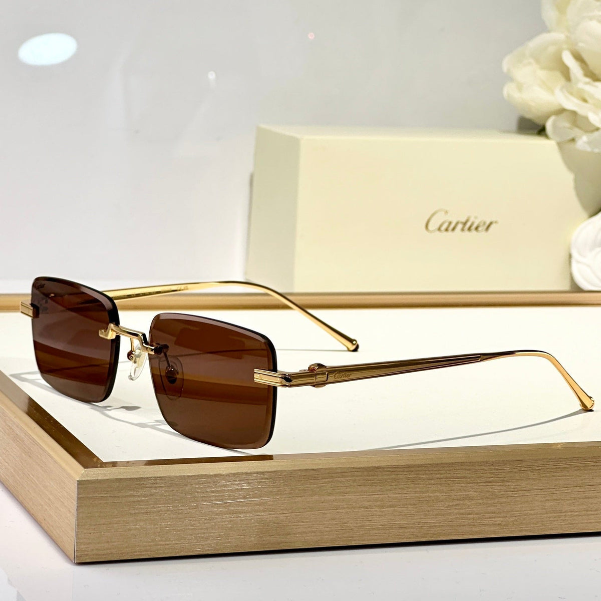 CARTIER C DE RIMLESS SQUARE FRAME SUNGLASSES CT0610S IN METAL