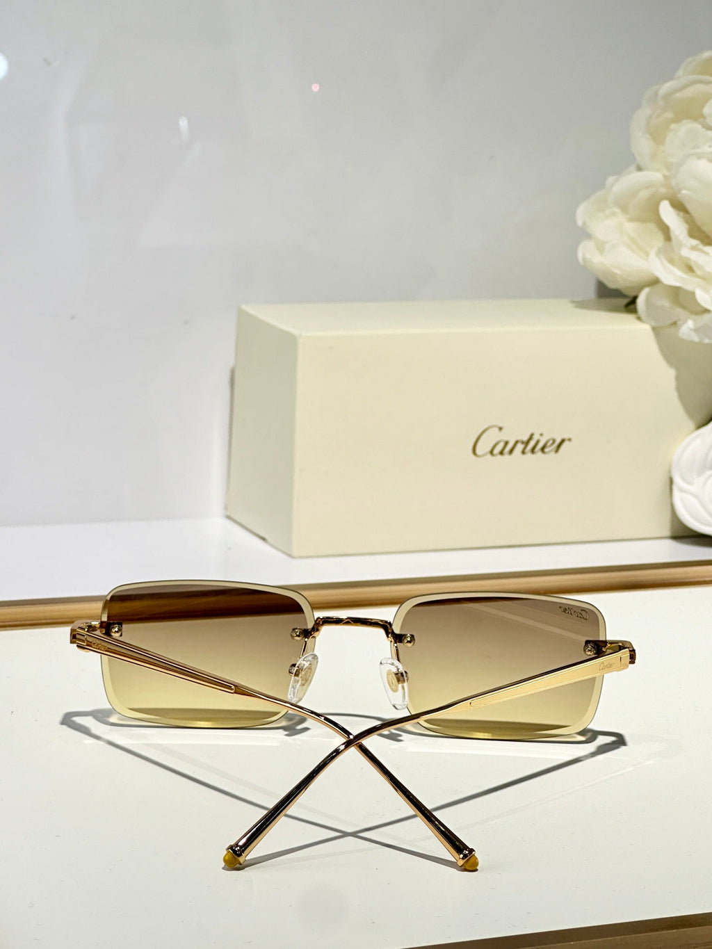 CARTIER C DE RIMLESS SQUARE FRAME SUNGLASSES CT0610S IN METAL