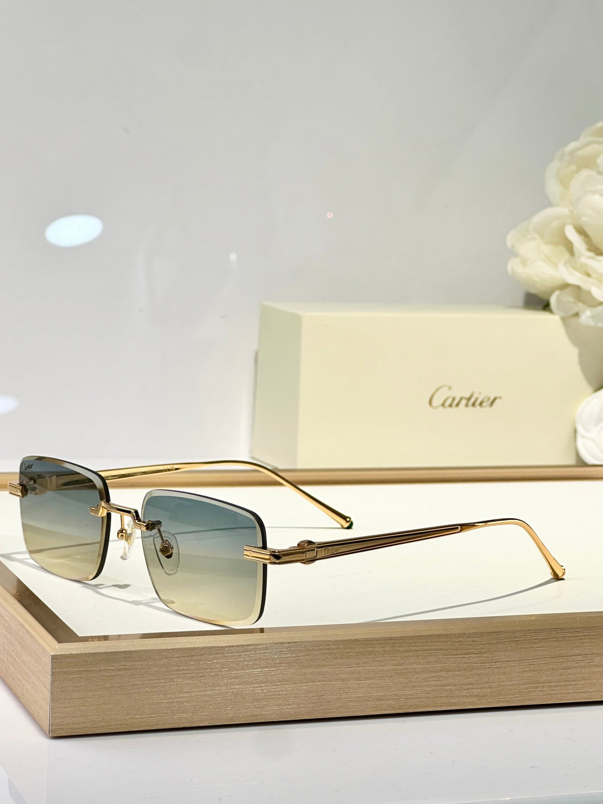 CARTIER C DE RIMLESS SQUARE FRAME SUNGLASSES CT0610S IN METAL