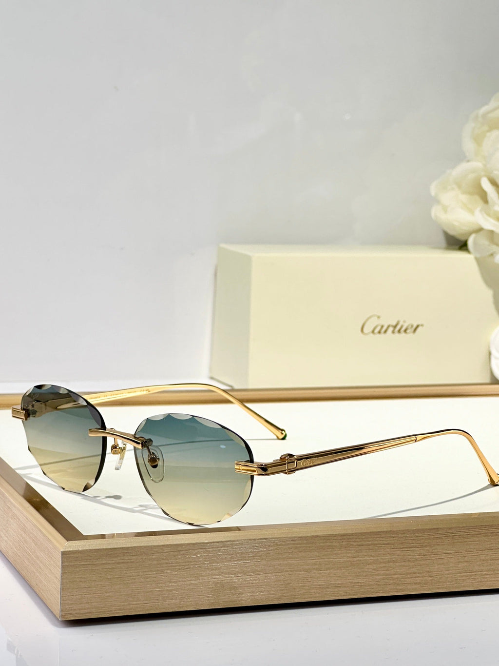 CARTIER C DE RIMLESS ROUND FRAME SUNGLASSES CT0611S IN METAL