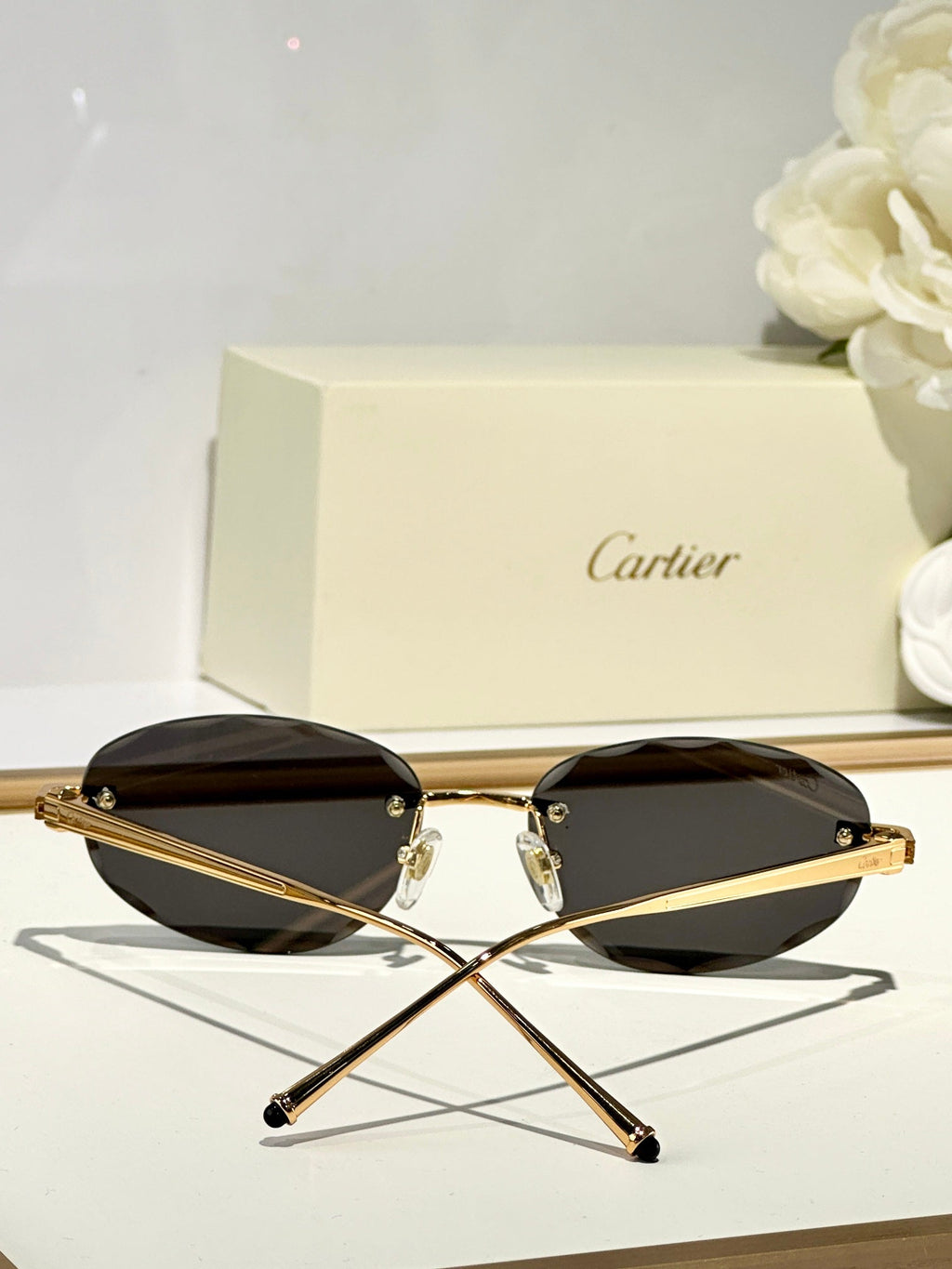 CARTIER C DE RIMLESS ROUND FRAME SUNGLASSES CT0611S IN METAL
