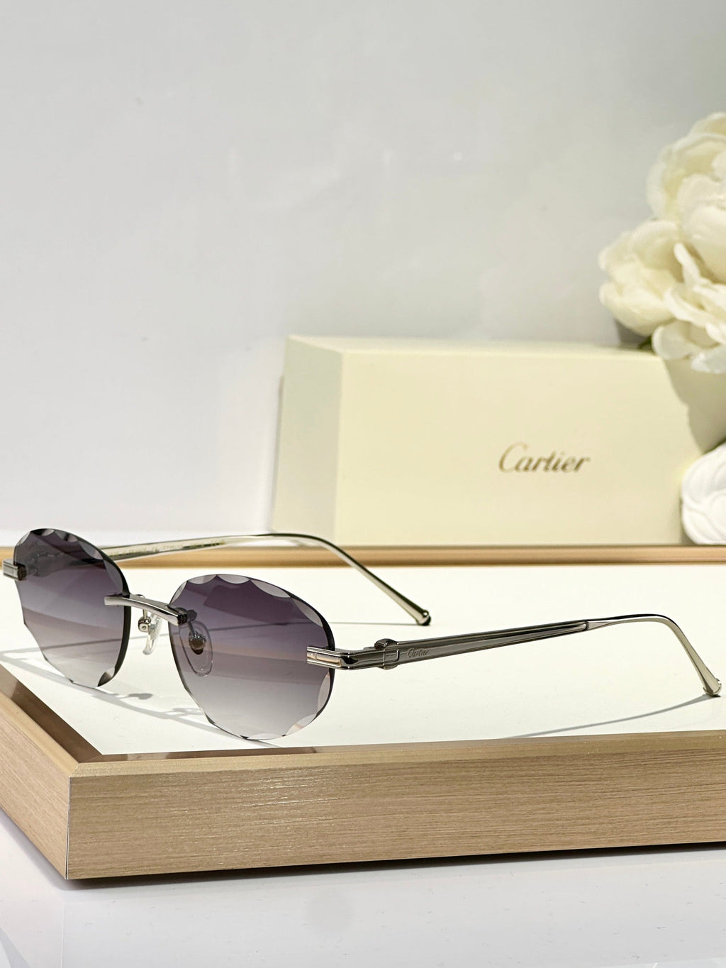 CARTIER C DE RIMLESS ROUND FRAME SUNGLASSES CT0611S IN METAL