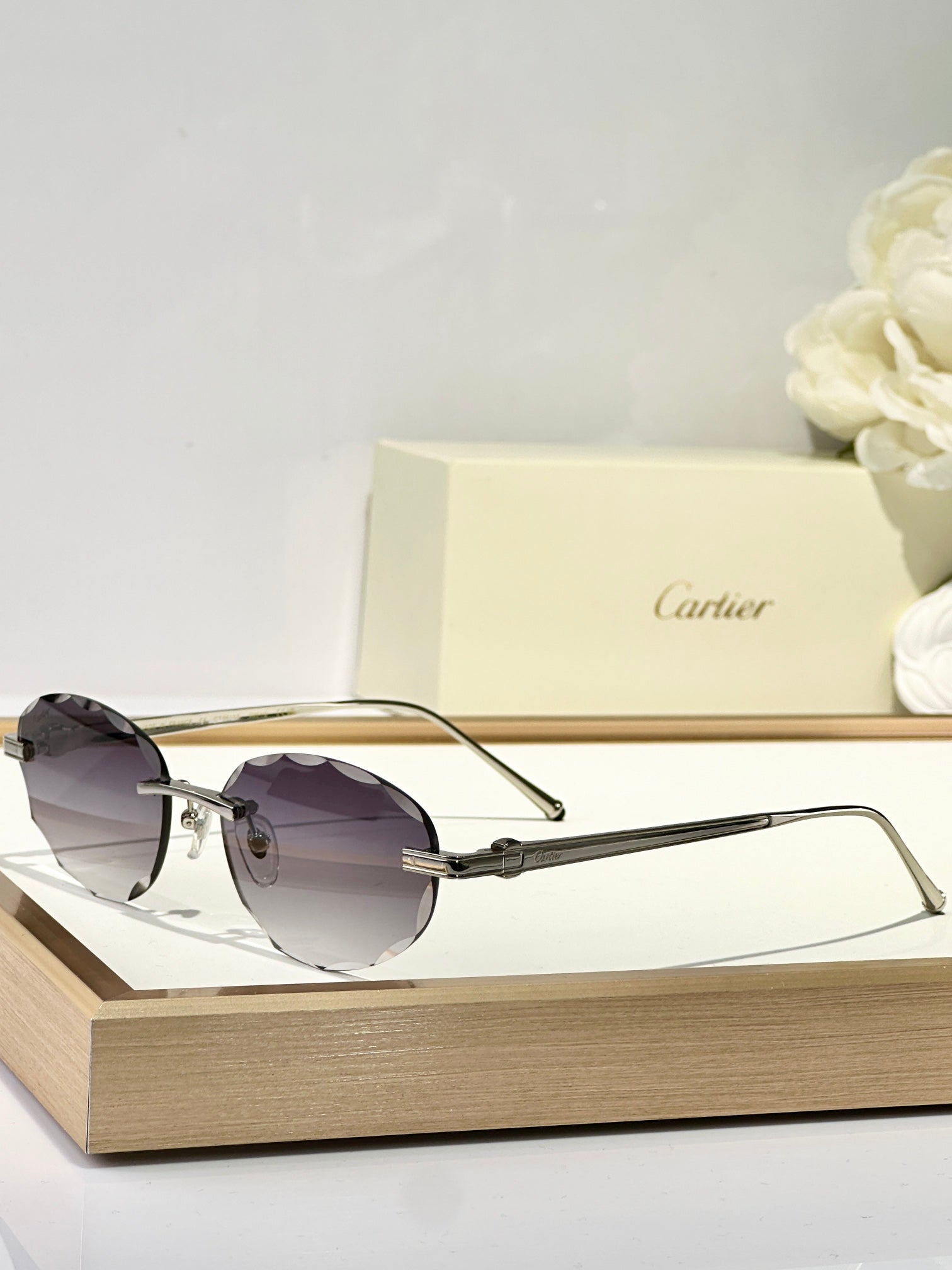 CARTIER C DE RIMLESS ROUND FRAME SUNGLASSES CT0611S IN METAL