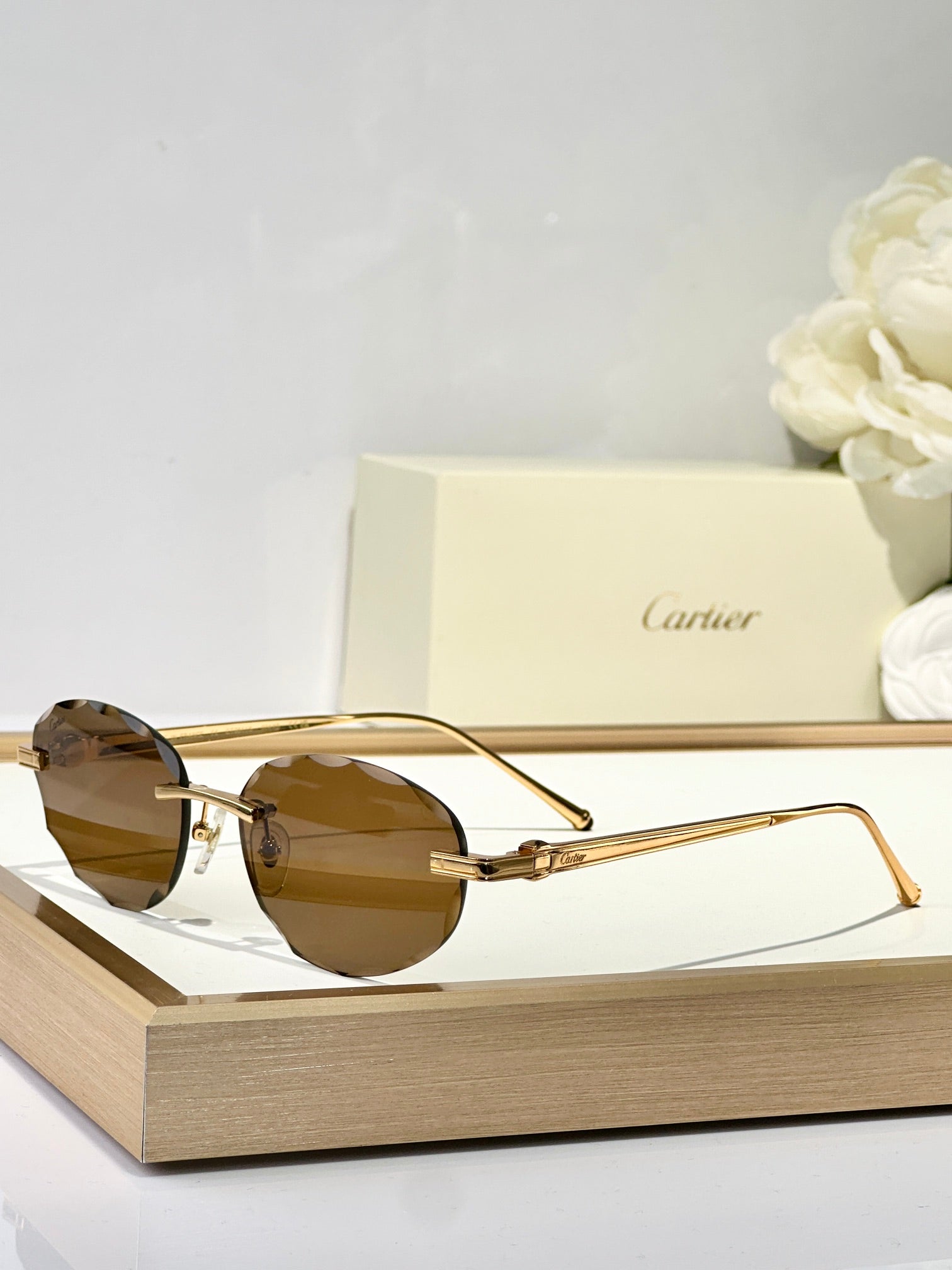 CARTIER C DE RIMLESS ROUND FRAME SUNGLASSES CT0611S IN METAL