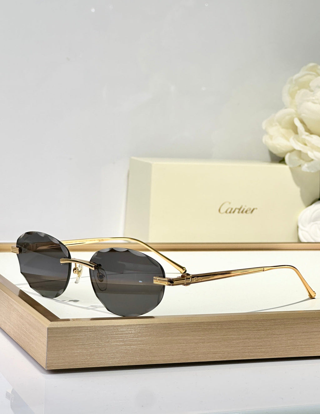 CARTIER C DE RIMLESS ROUND FRAME SUNGLASSES CT0611S IN METAL