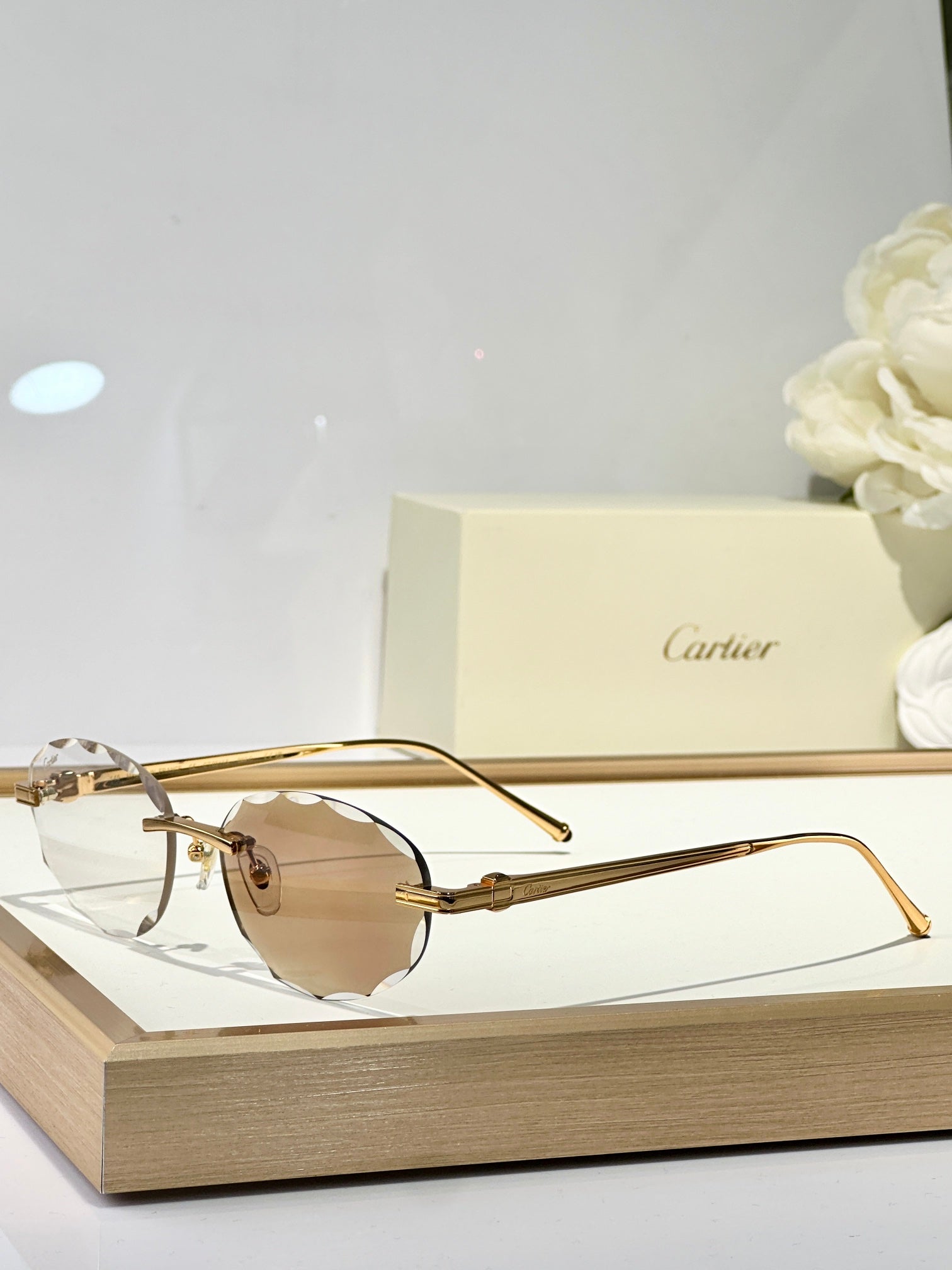 CARTIER C DE RIMLESS ROUND FRAME SUNGLASSES CT0611S IN METAL