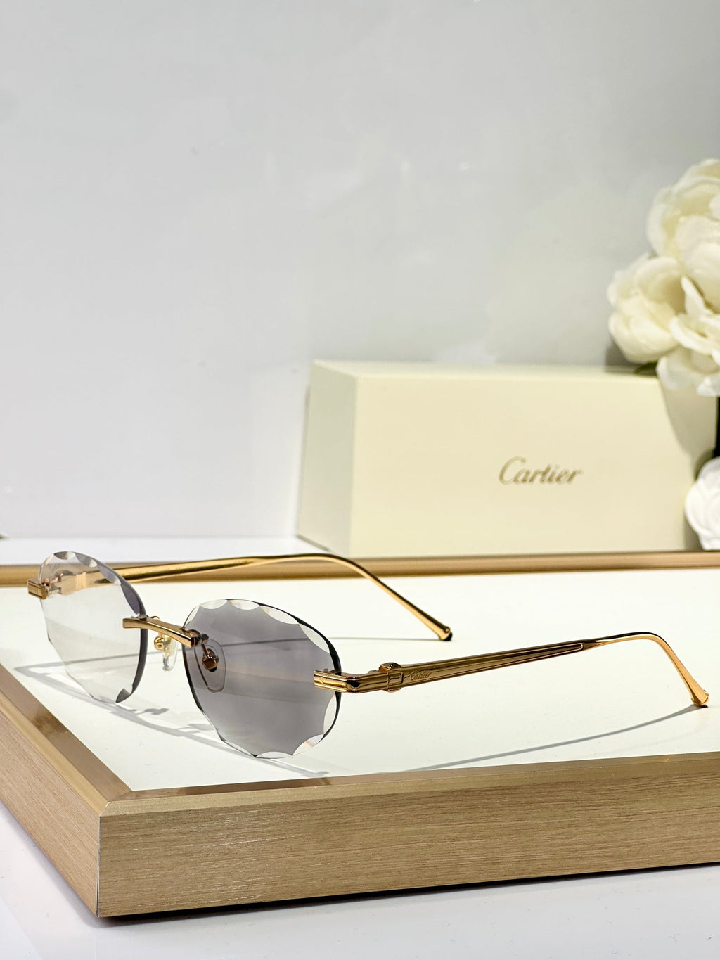 CARTIER C DE RIMLESS ROUND FRAME SUNGLASSES CT0611S IN METAL