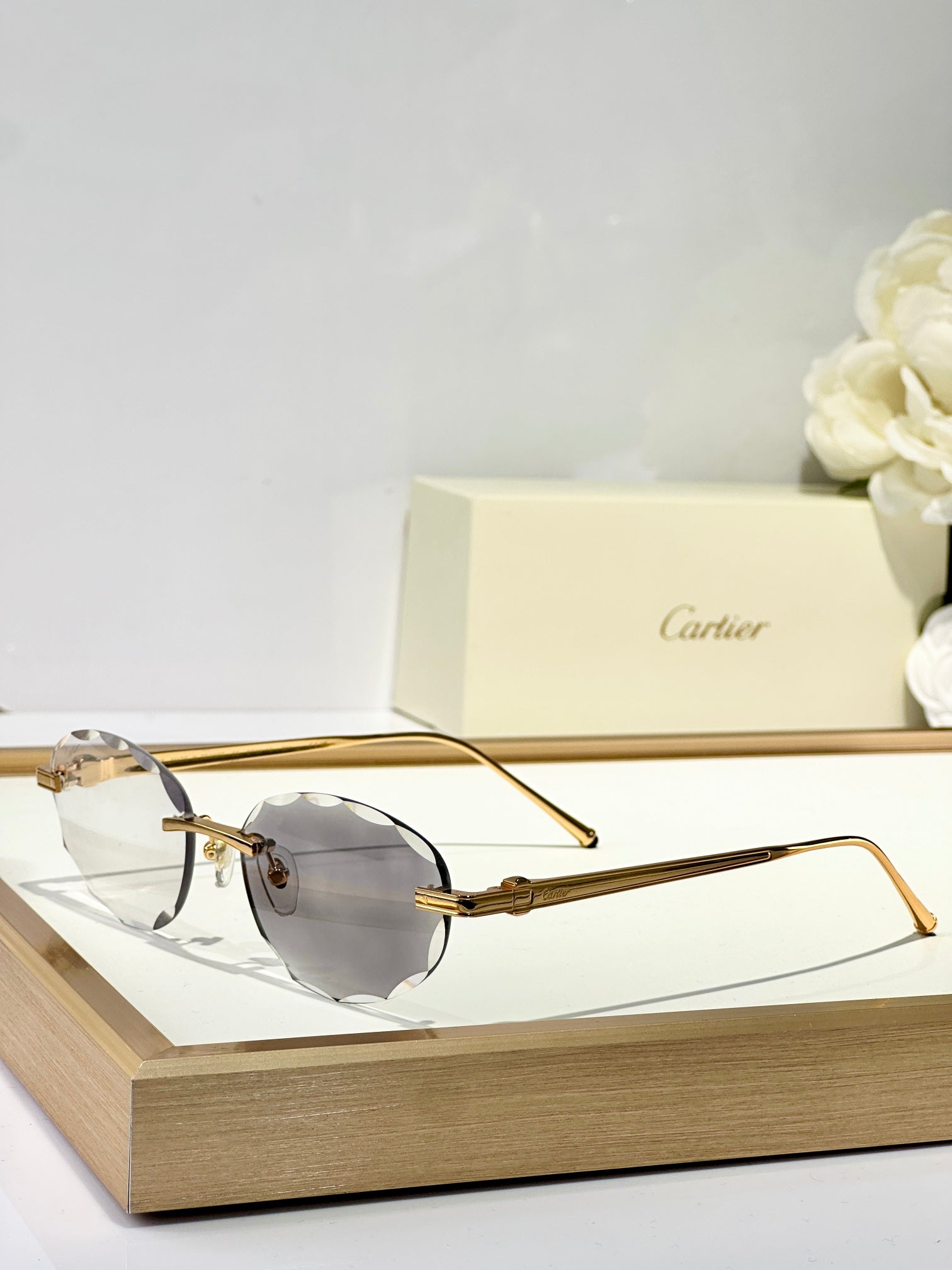 CARTIER C DE RIMLESS ROUND FRAME SUNGLASSES CT0611S IN METAL