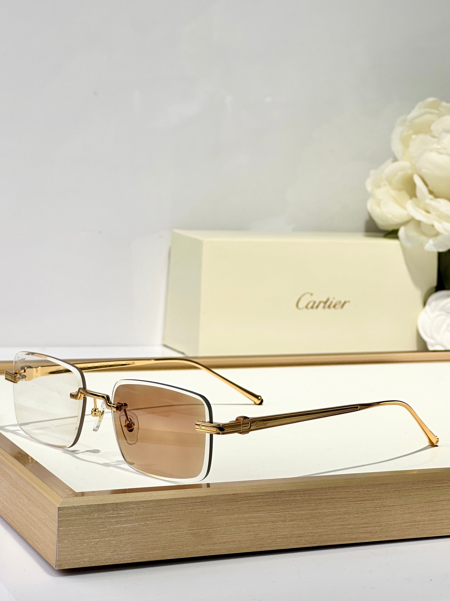 CARTIER C DE RIMLESS SQUARE FRAME SUNGLASSES CT0610S IN METAL
